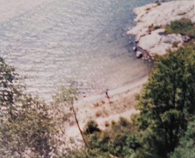 'A lone figure on the beach, viewed from above.'